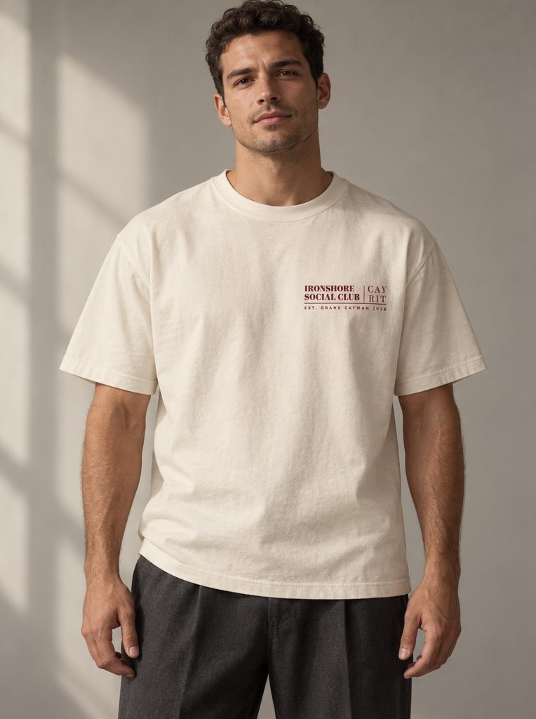 Studio render: a man in a bone T-shirt with a small Ironshore Social Club crest on the chest.